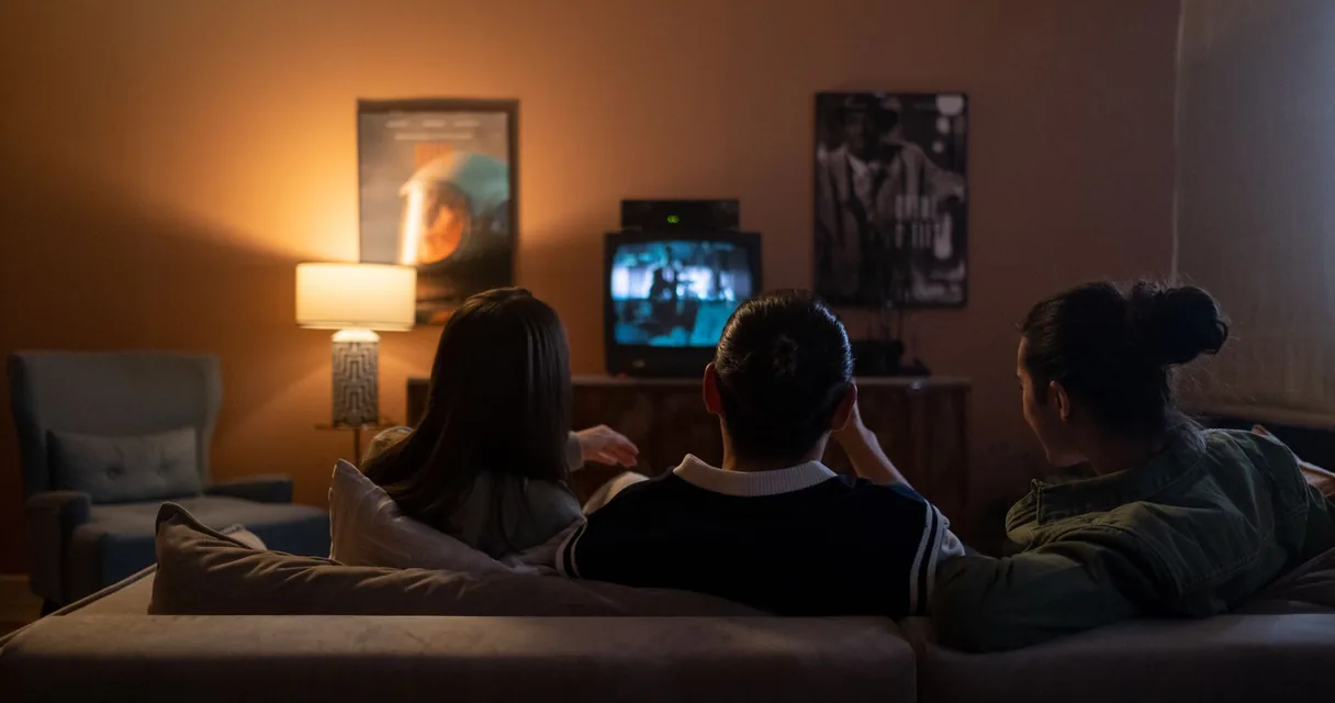Amigos assistindo TV na sala durante o teste IPTV grátis da Agora IPTV